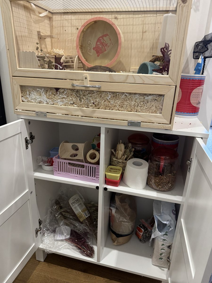 Potato's home on its white cabinet, with cleaning supplies stored below